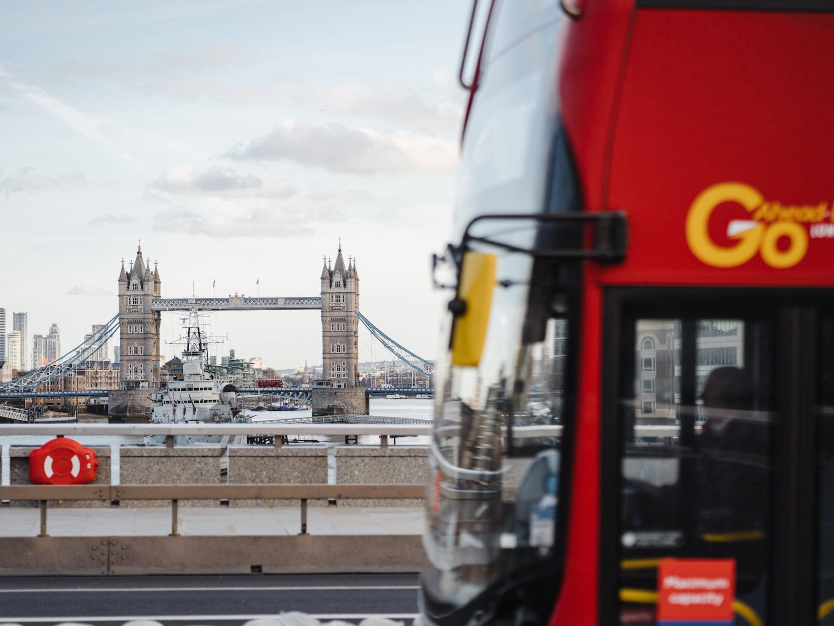 bus on the road with bridge on the river background